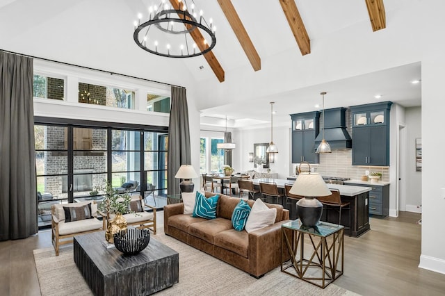 living room with beam ceiling, light hardwood / wood-style flooring, and high vaulted ceiling