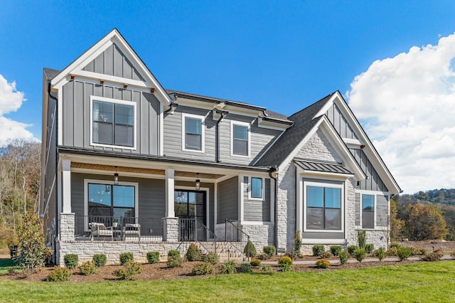 craftsman house with covered porch and a front lawn