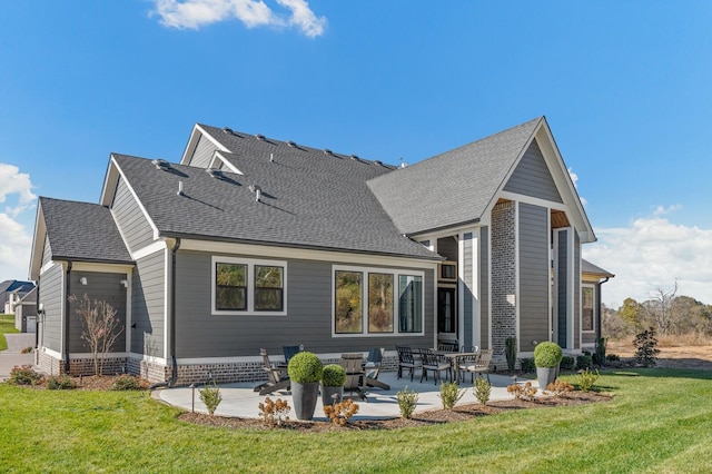 back of property featuring a yard and a patio