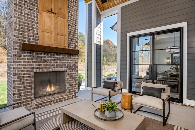 view of patio / terrace featuring an outdoor brick fireplace