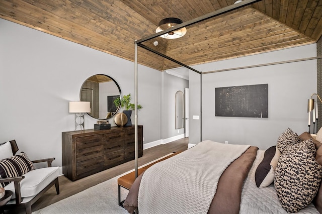 bedroom featuring lofted ceiling, hardwood / wood-style floors, and wooden ceiling