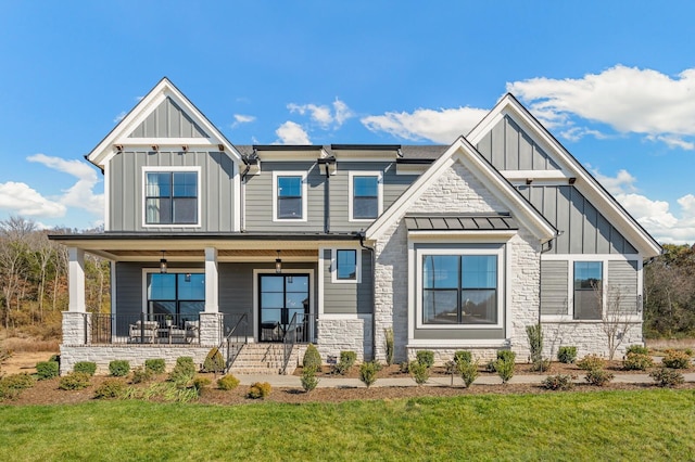 view of front of house featuring covered porch and a front lawn