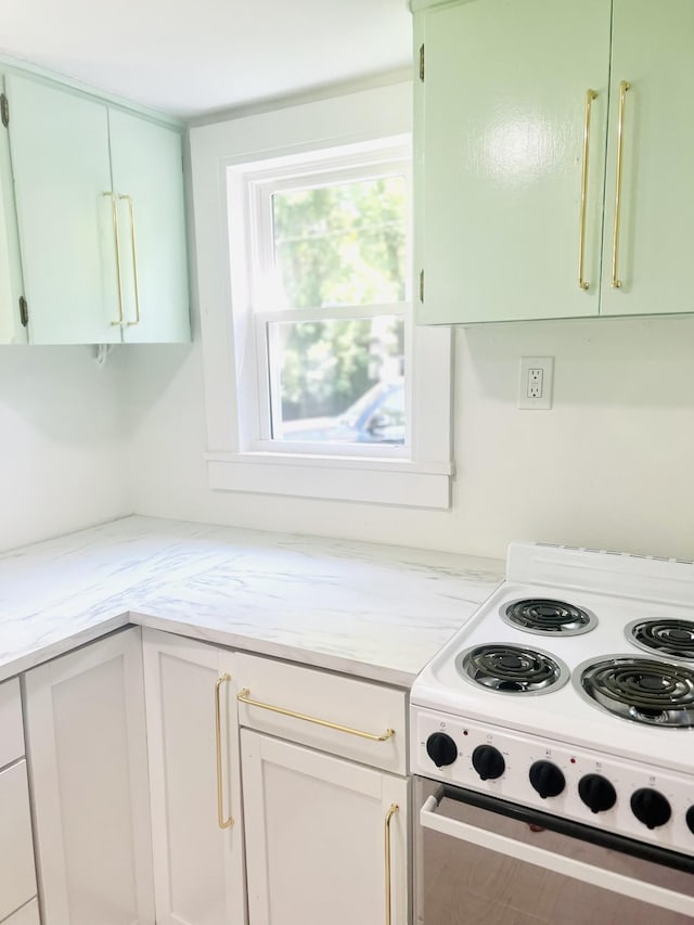 kitchen with white electric range and light stone counters