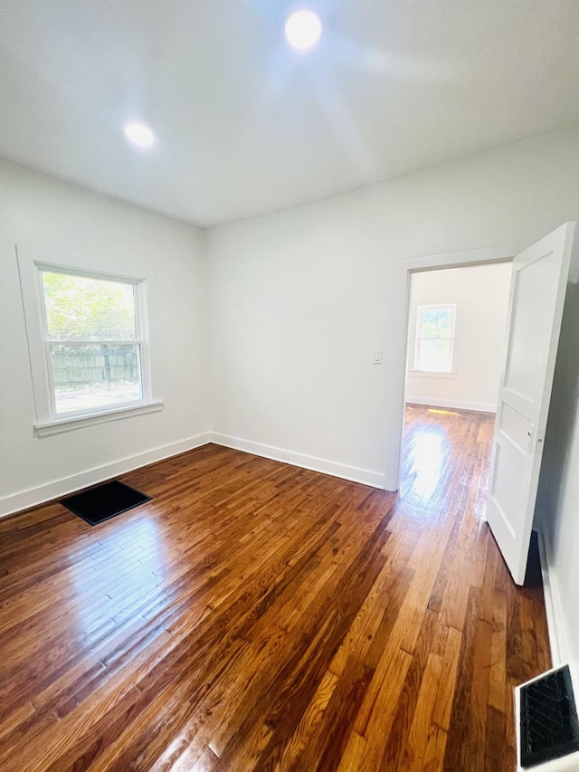 empty room with hardwood / wood-style flooring