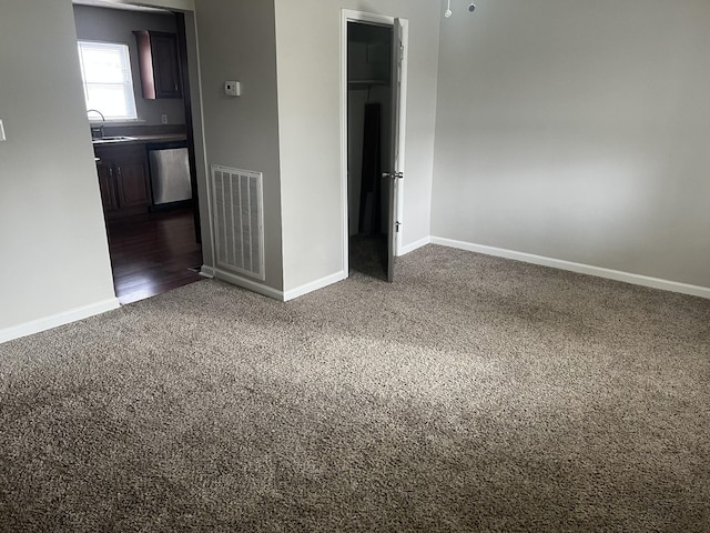 carpeted empty room with sink