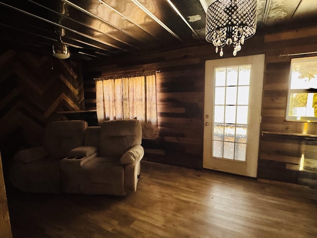 living area featuring hardwood / wood-style floors and wooden walls