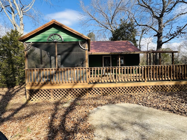 back of house with a deck