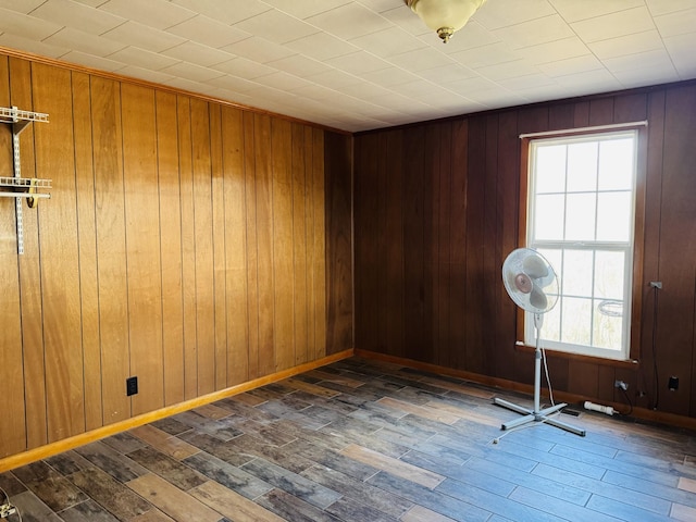 unfurnished room featuring dark hardwood / wood-style floors and wood walls