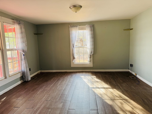 unfurnished room with dark hardwood / wood-style flooring