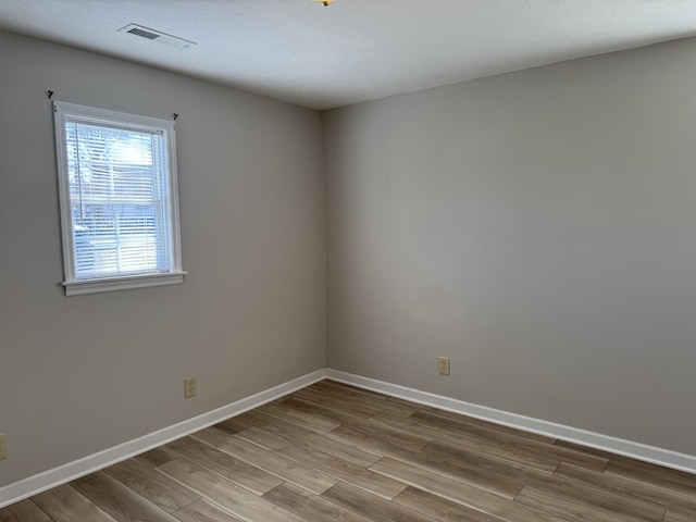 spare room with hardwood / wood-style flooring