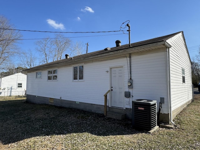 rear view of property featuring central AC