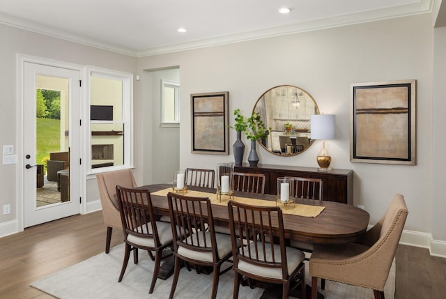 dining room with ornamental molding and dark hardwood / wood-style floors