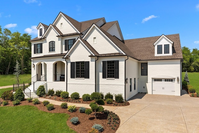 view of front of property with a porch, a garage, and a front lawn