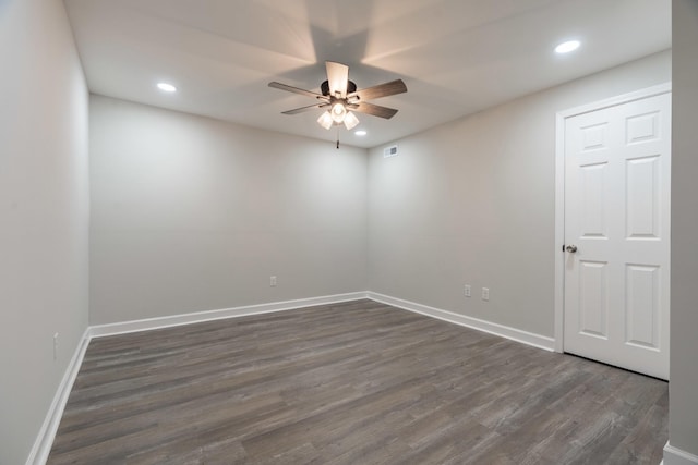 empty room featuring dark wood-type flooring and ceiling fan