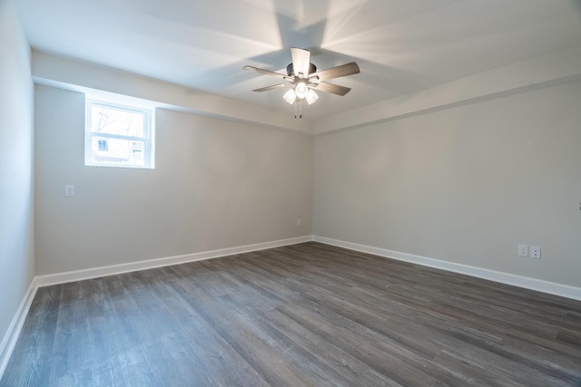 spare room featuring dark wood-type flooring and ceiling fan