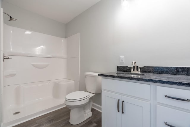 bathroom with vanity, a shower, hardwood / wood-style floors, and toilet