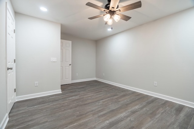 empty room featuring dark wood-type flooring and ceiling fan