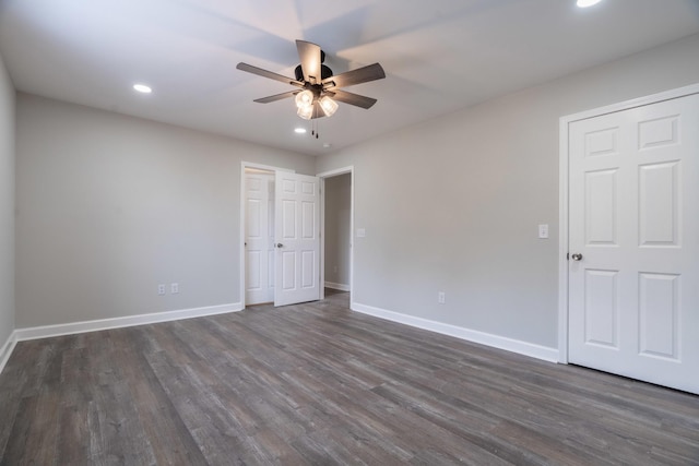 empty room with dark wood-type flooring and ceiling fan