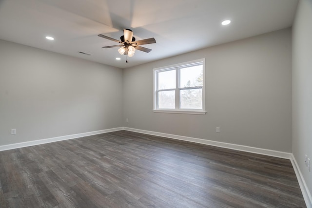 unfurnished room featuring ceiling fan and dark hardwood / wood-style flooring