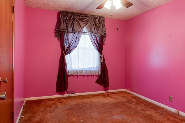 spare room featuring ceiling fan, carpet, and a textured ceiling