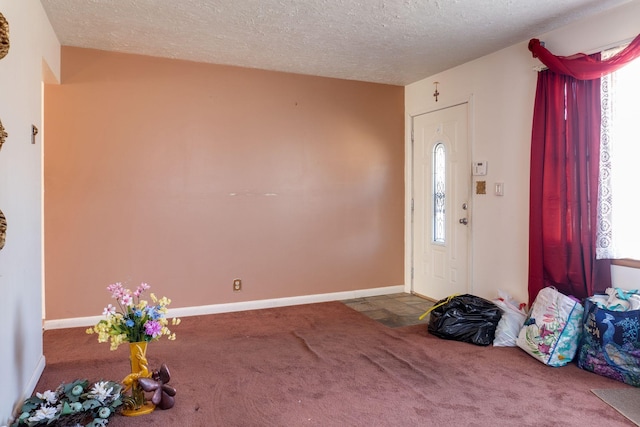 carpeted entrance foyer with a textured ceiling