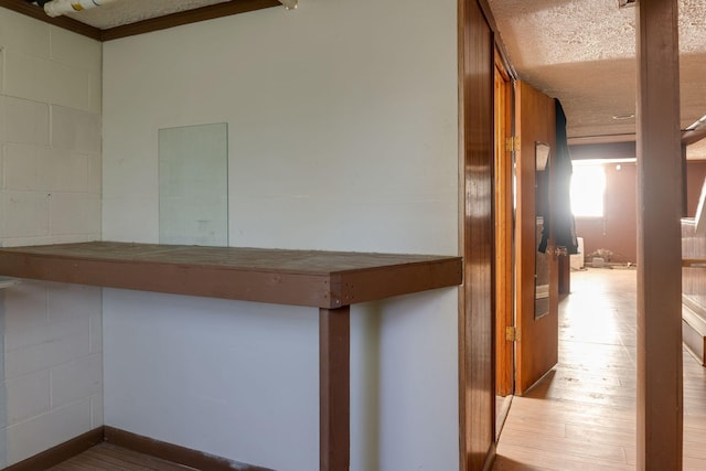 hallway with light hardwood / wood-style floors