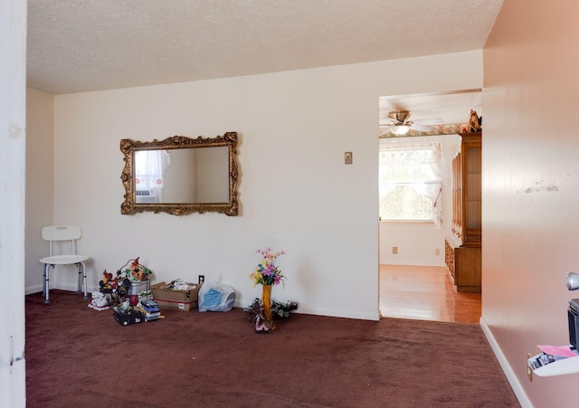 spare room with carpet floors and a textured ceiling