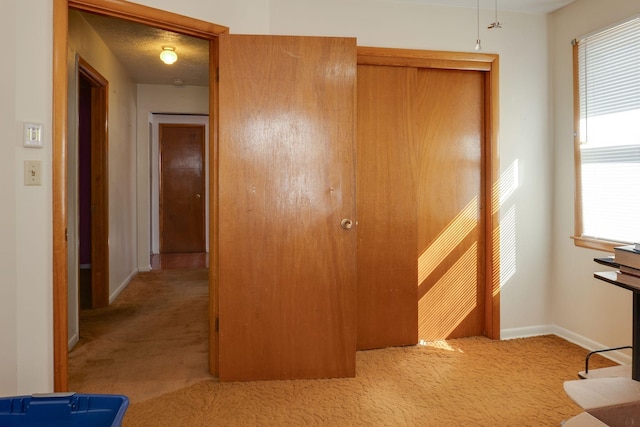 unfurnished bedroom with light carpet and a textured ceiling