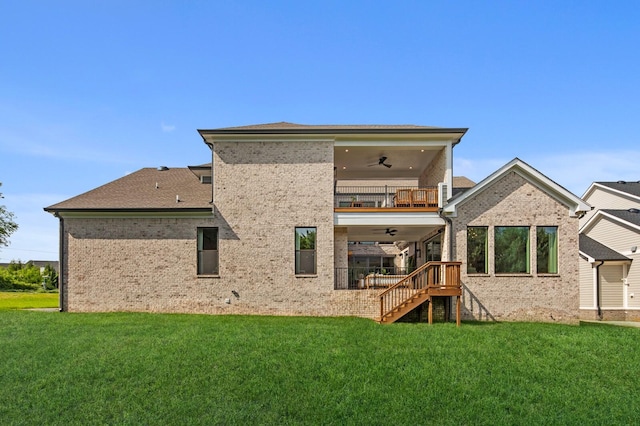 rear view of house featuring a balcony, ceiling fan, and a lawn