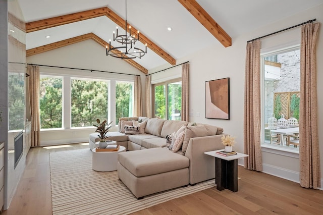 living room featuring an inviting chandelier, light hardwood / wood-style flooring, and vaulted ceiling with beams