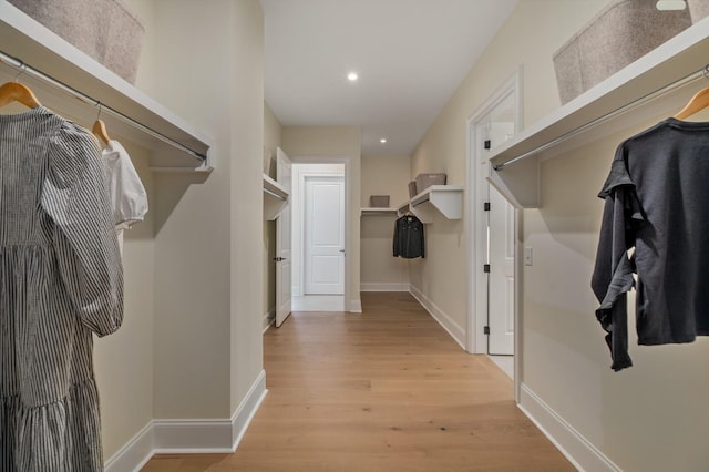 spacious closet with light hardwood / wood-style floors