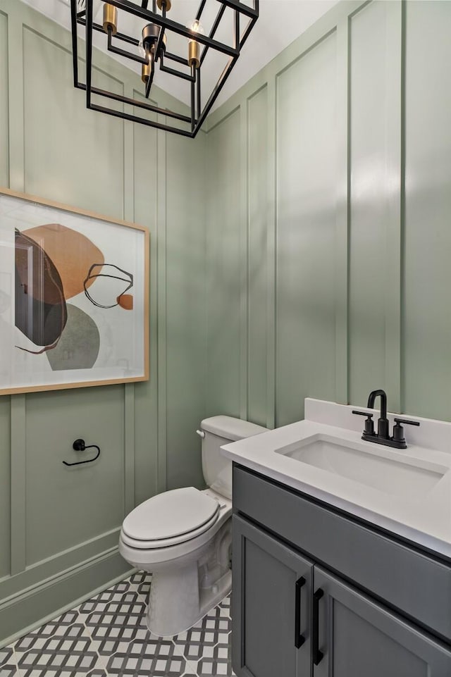 bathroom featuring vanity, tile patterned floors, and toilet