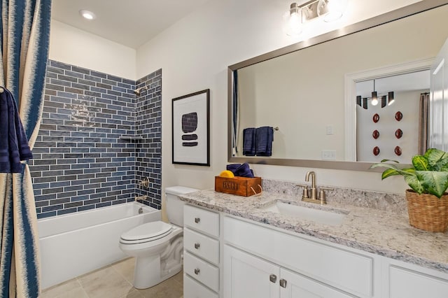 full bathroom featuring tiled shower / bath, vanity, toilet, and tile patterned floors