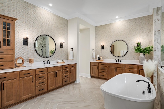 bathroom featuring parquet floors, ornamental molding, vanity, and a tub