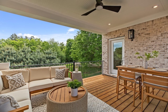 wooden terrace with an outdoor hangout area and ceiling fan