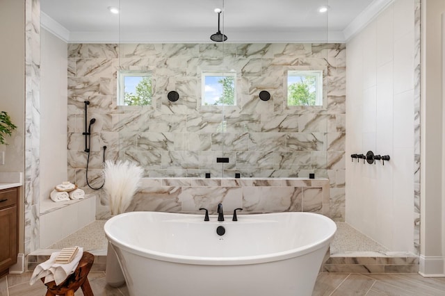 bathroom featuring shower with separate bathtub, tile walls, vanity, and crown molding