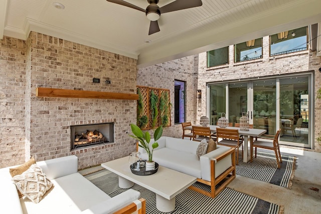 view of patio / terrace featuring an outdoor living space with a fireplace and ceiling fan