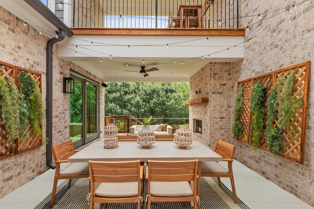 view of patio / terrace featuring an outdoor brick fireplace and ceiling fan