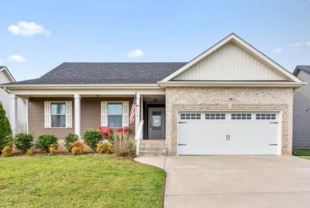 view of front of house featuring a garage and a front lawn