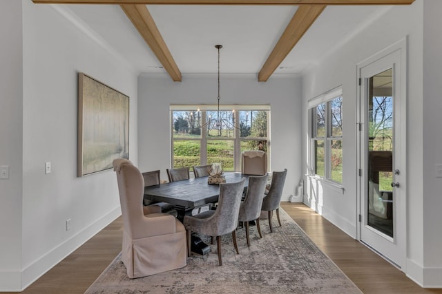 dining room with dark wood-type flooring, a notable chandelier, and beam ceiling