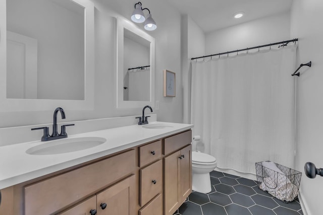 bathroom with a shower with curtain, tile patterned floors, vanity, and toilet