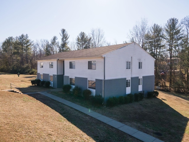 view of property exterior with a yard