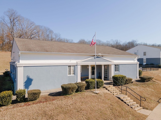 single story home featuring a front lawn and a porch