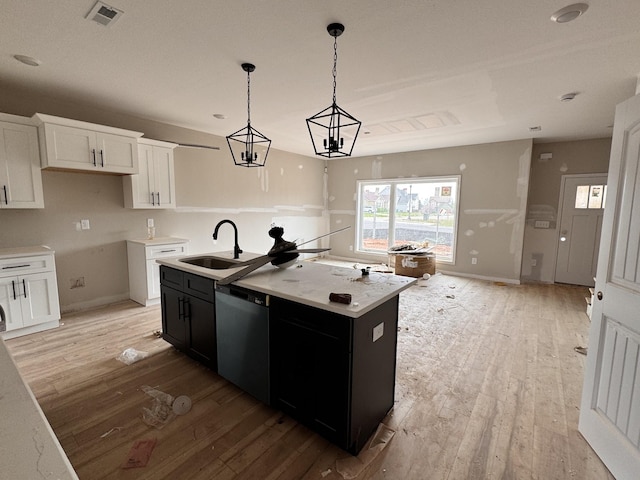 2363 Pea Ridge Rd, Clarksville, TN 37040 - kitchen featuring light wood-style flooring, visible vents, dishwasher, a sink, and baseboards