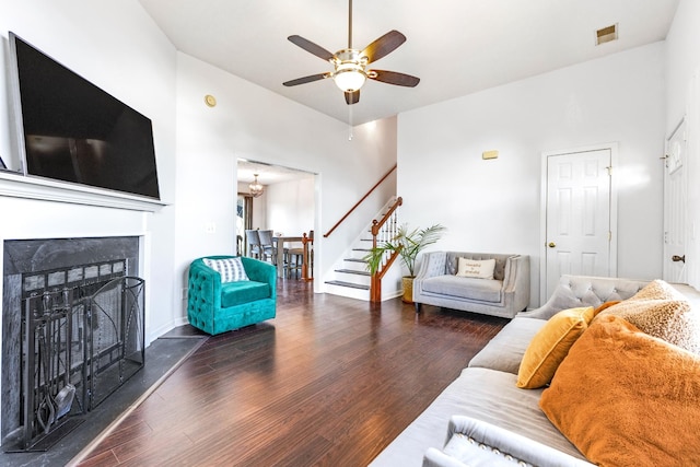 living room featuring ceiling fan and dark hardwood / wood-style floors