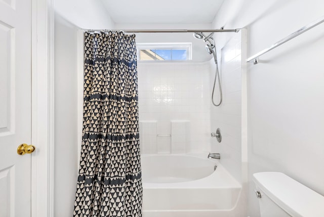 bathroom featuring shower / tub combo and toilet