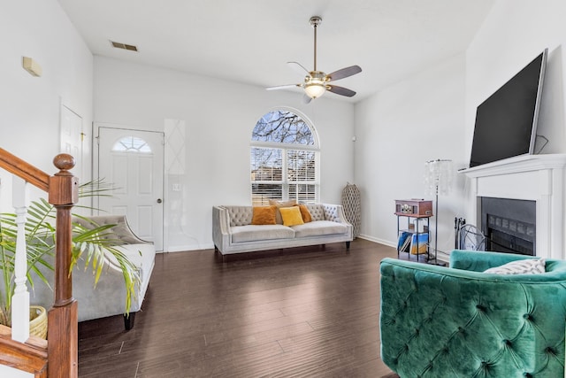 living room with ceiling fan and dark hardwood / wood-style flooring