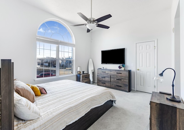 bedroom with light carpet and ceiling fan