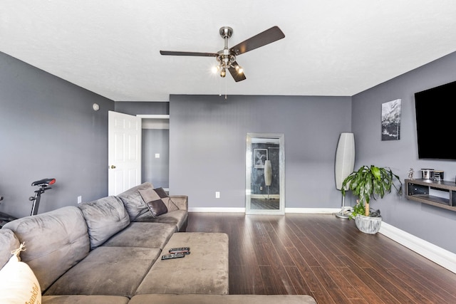 living room featuring dark hardwood / wood-style floors and ceiling fan