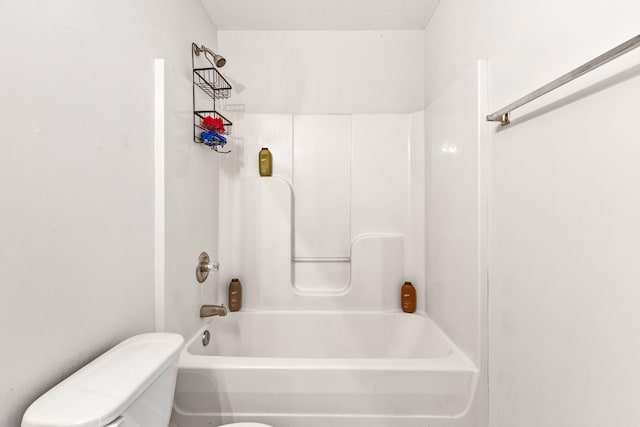 bathroom featuring shower / bathtub combination and toilet